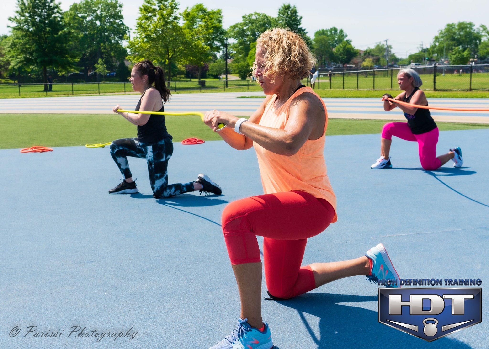 Group exercising with resistance bands outdoors