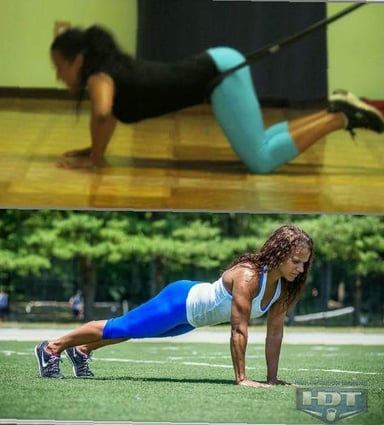Two women performing push-ups with resistance bands