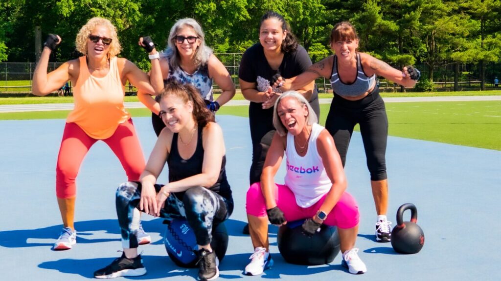 Women posing together after an energetic outdoor group fitness workout