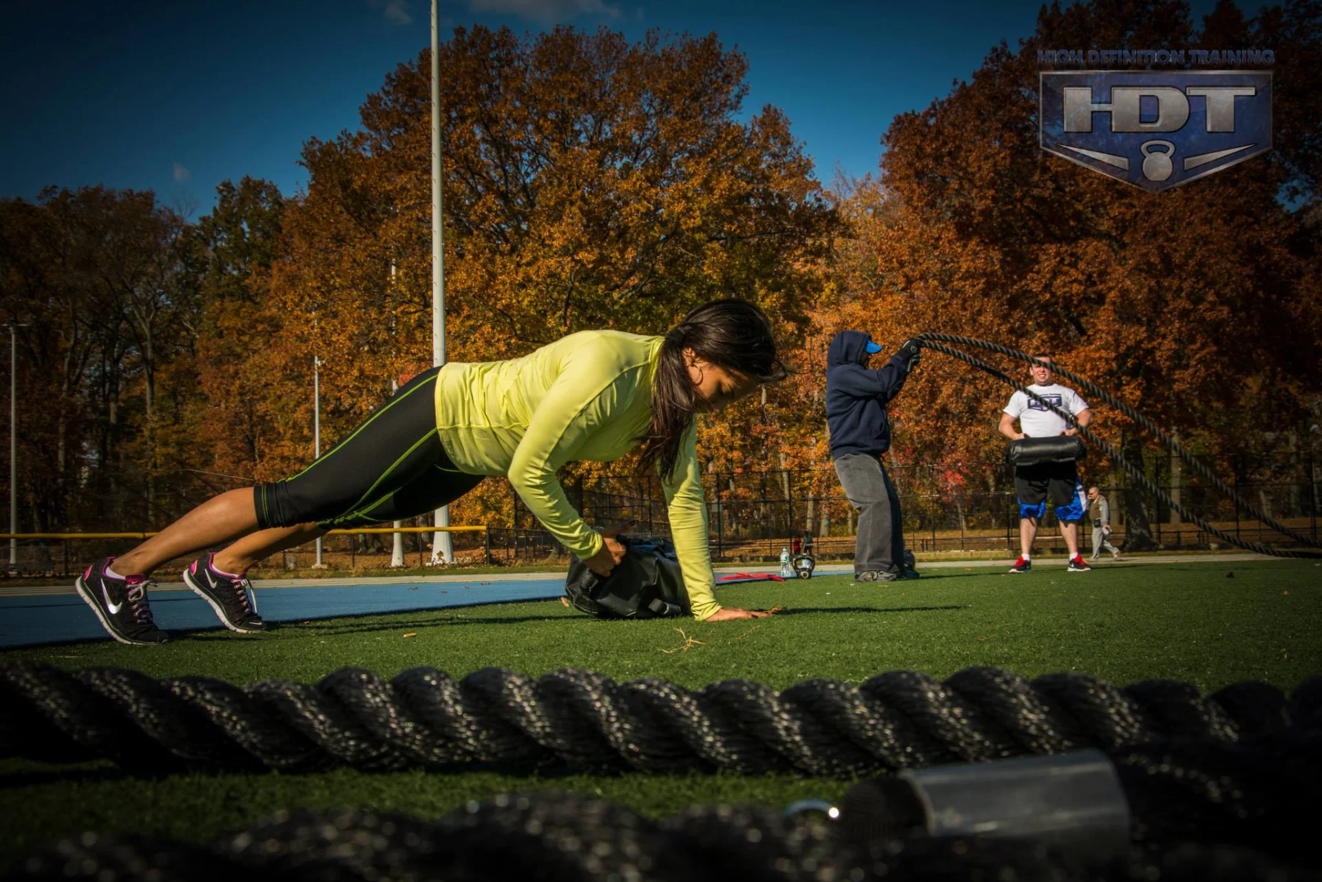 Woman performing an outdoor strength exercise during an intensive fitness training session